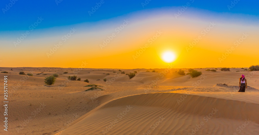 Jeep safari at sunset over sand dunes in Dubai Desert Conservation Reserve, United Arab Emirates. Copy space for text.