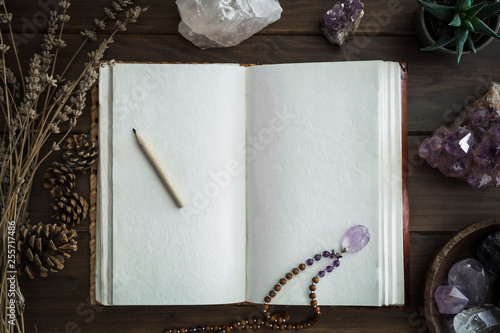 Fotografía Open Notebook Surrounded by Crystals Plants and Foliage