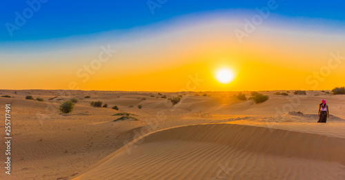 Jeep safari at sunset over sand dunes in Dubai Desert Conservation Reserve, United Arab Emirates. Copy space for text.