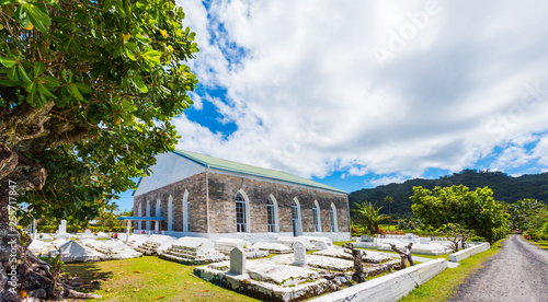 ARUTANGA, AITUTAKI, COOK ISLAND - SEPTEMBER 30, 2018: Christian Church of the Cook Islands. Burial place on the territory of the church. photo