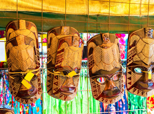 ARUTANGA, AITUTAKI, COOK ISLAND - SEPTEMBER 30, 2018: Wooden masks in the local market. With selective focus. photo