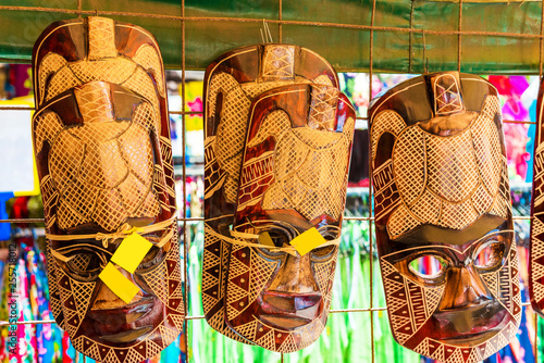 ARUTANGA, AITUTAKI, COOK ISLAND - SEPTEMBER 30, 2018: Wooden masks in the local market. With selective focus. photo