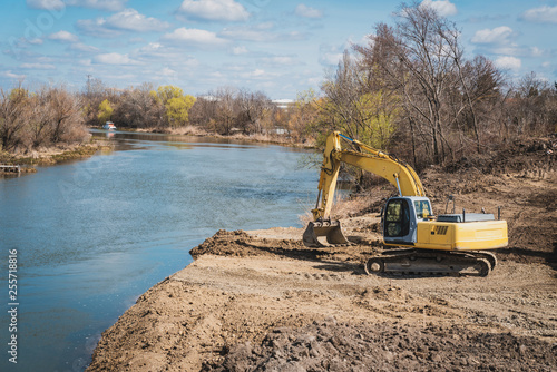 a large dredger prepares the land for the construction of a bridge
