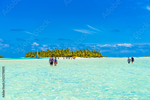 Wallpaper Mural People walking true turquoise sandbank, Aitutaki island, Cook Islands, South Pacific. Copy space for text... Torontodigital.ca