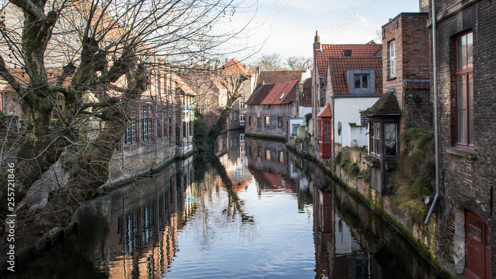 Popular touristic destination medieval historic city Brugge in West Flanders in the Flemish Region of Belgium. Brugge streets and historic center, canals and buildings