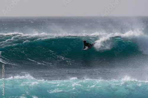 surfer against a deep blue wave  © Dirk