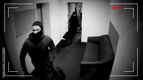 Undefined thieves escaping from place of crime, armed robbery, CCTV effect photo