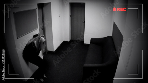 Fotografi Woman losing consciousness in office corridor, poisoning, CCTV camera effect