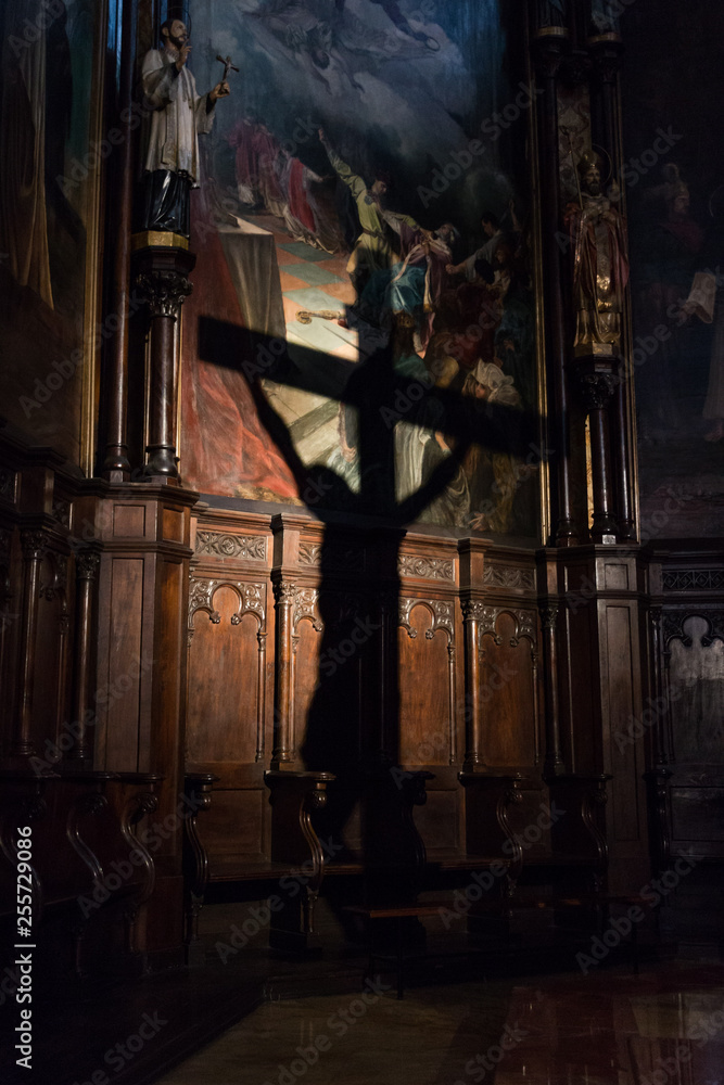 Projection of the shadow of the crucifix on the wall of a church