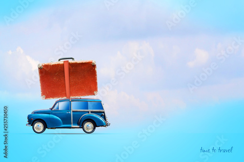 Blue old cars with a suitcase on the trunk. On a blue background. Travel concept. Summer