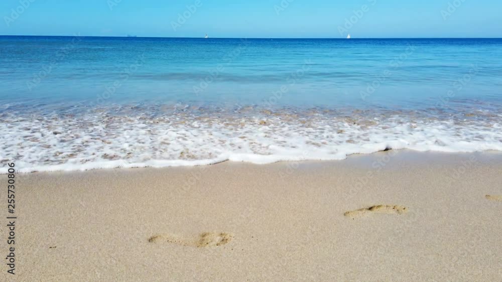 Footprints of barefoot foots at sand beach broke by surf waves. 4K footage Footprints of barefoot foots at sand beach broke by surf waves. 4K footage