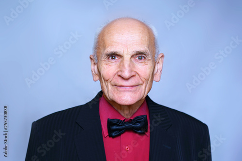 portrait of an old pensioner in a suit and black bow-tie