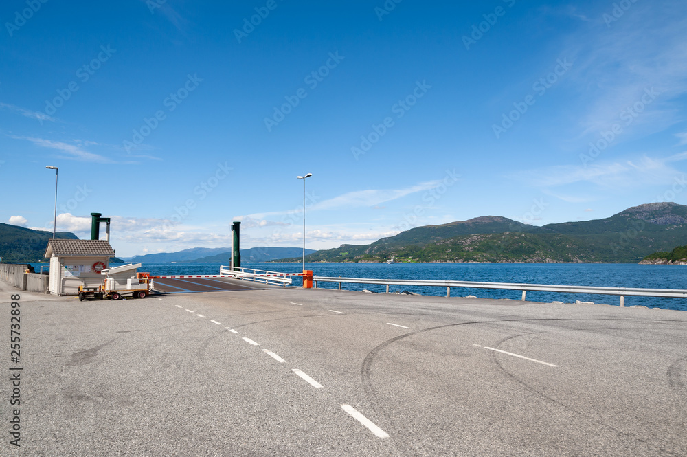 Open road. Harbor, harbour for ferries. Empty road with no traffic in countryside. Rural landscape. Ryfylke scenic route. Norway. Europe.