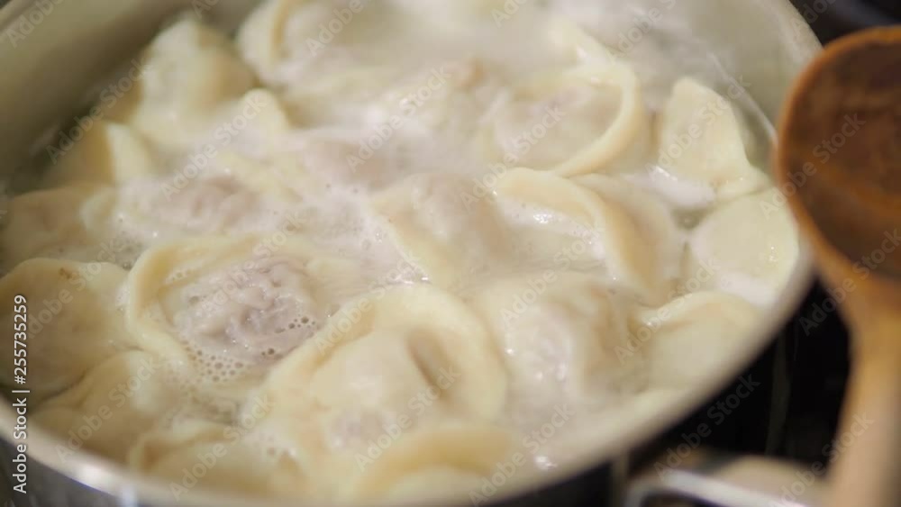 Boiling dumplings. Hot water with traditional dish of Russian cuisine. Boiling dumplings. Hot water with traditional dish of Russian cuisine.