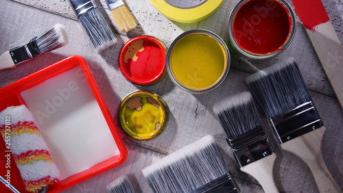 Paintbrushes of different size and paint can photo