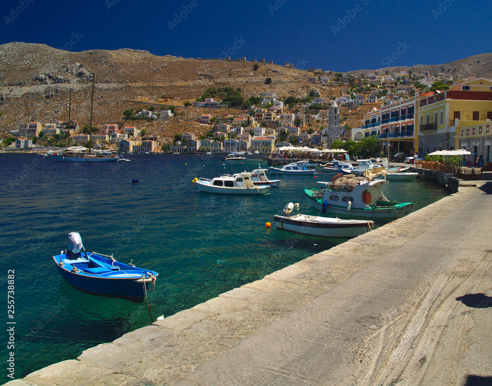 Simi island port, Greece. Summer day view to traditional greek island port with boats.