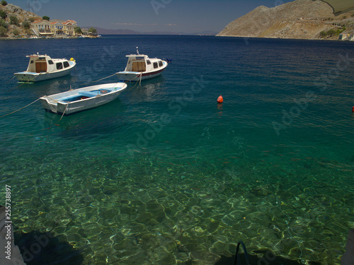 Simi island port, Greece. Summer day view to traditional greek island port with boats.