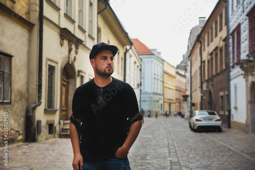 Young man in city centre near buildings