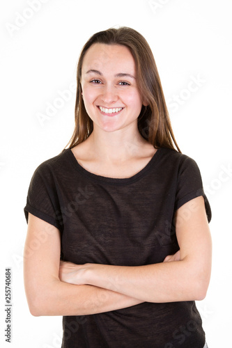 Smiling young woman on white background arms crossed © OceanProd