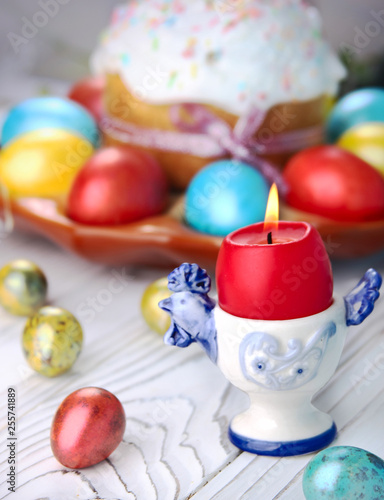 Easter bread and colorful eggs on a wooden, white background. Easter background.
