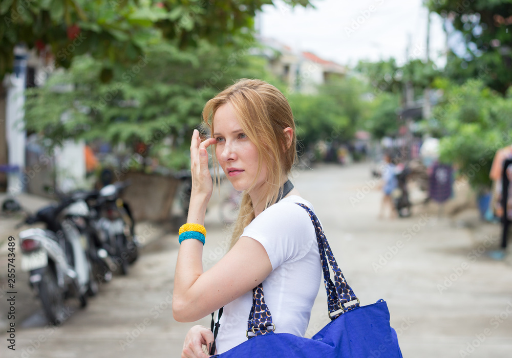 young attractive woman with blue handbag