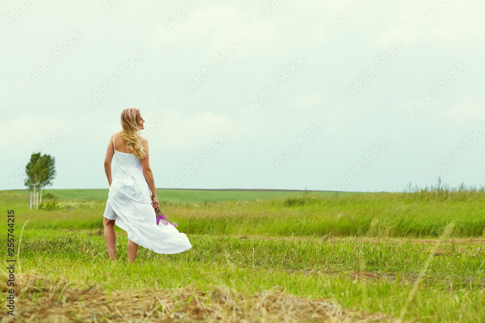 outdoor portrait of a middle aged blonde woman. attractive sexy girl on road in a field outdoor portrait of a middle aged blonde woman. attractive sexy girl on road in a field