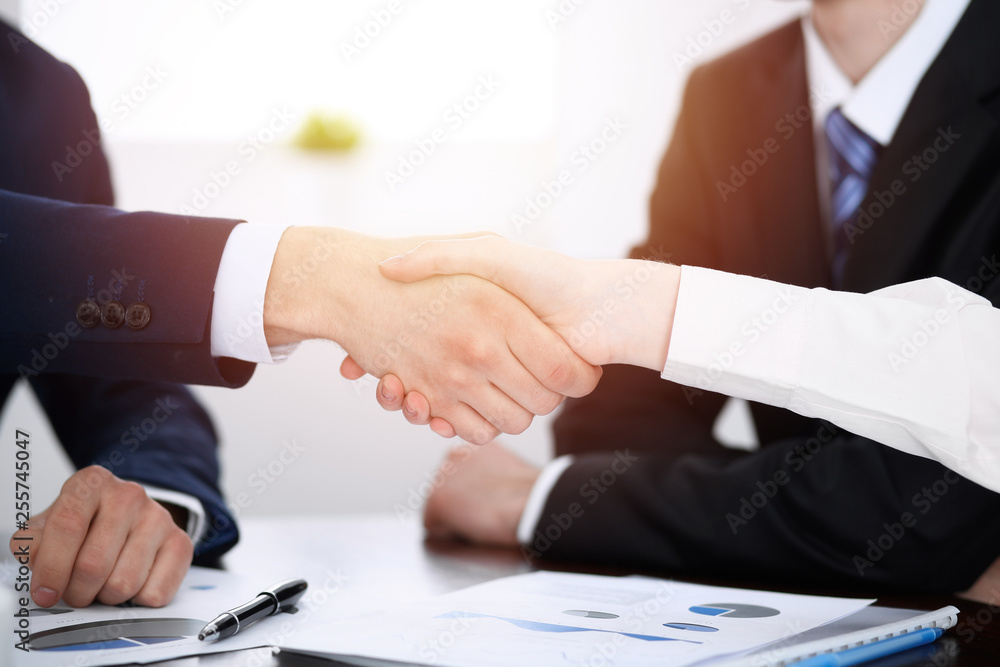 Business people shaking hands finishing up a meeting. Handshake at successful negotiation Business people shaking hands finishing up a meeting. Handshake at successful negotiation