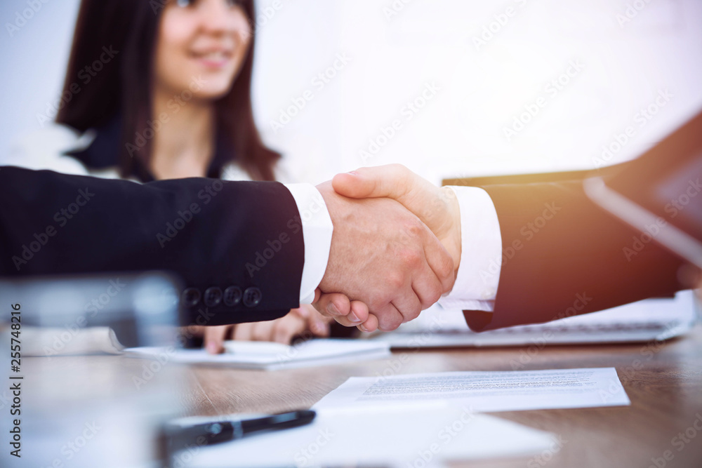Business people shaking hands at meeting or negotiation in the office. Handshake concept. Partners are satisfied because signing contract Business people shaking hands at meeting or negotiation in the office. Handshake concept. Partners are satisfied because signing contract