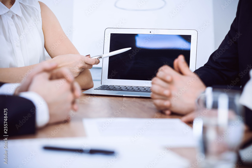 Group of businesspeople or lawyers discussing contract papers and financial figures while sitting at the table. Close-up of human hands at meeting or negotiations. Success and communication concept Group of businesspeople or lawyers discussing contract papers and financial figures while sitting at the table. Close-up of human hands at meeting or negotiations. Success and communication concept