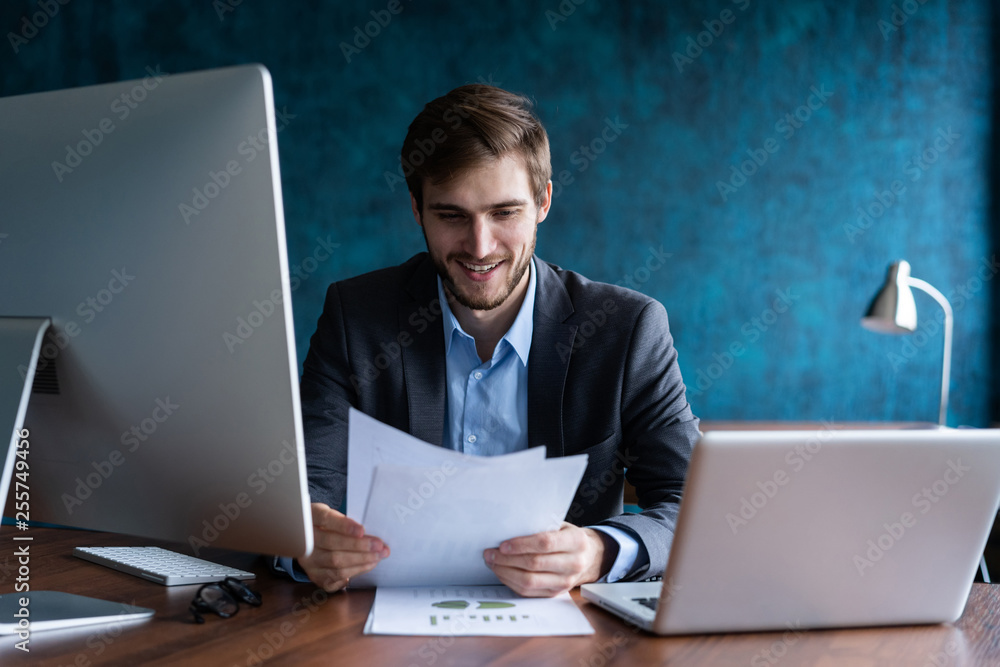Man Working At Computer In Contemporary Office. Man Working At Computer In Contemporary Office.
