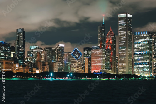 Downtown Chicago cityscape skyline at night with Lake Michigan in the foreground