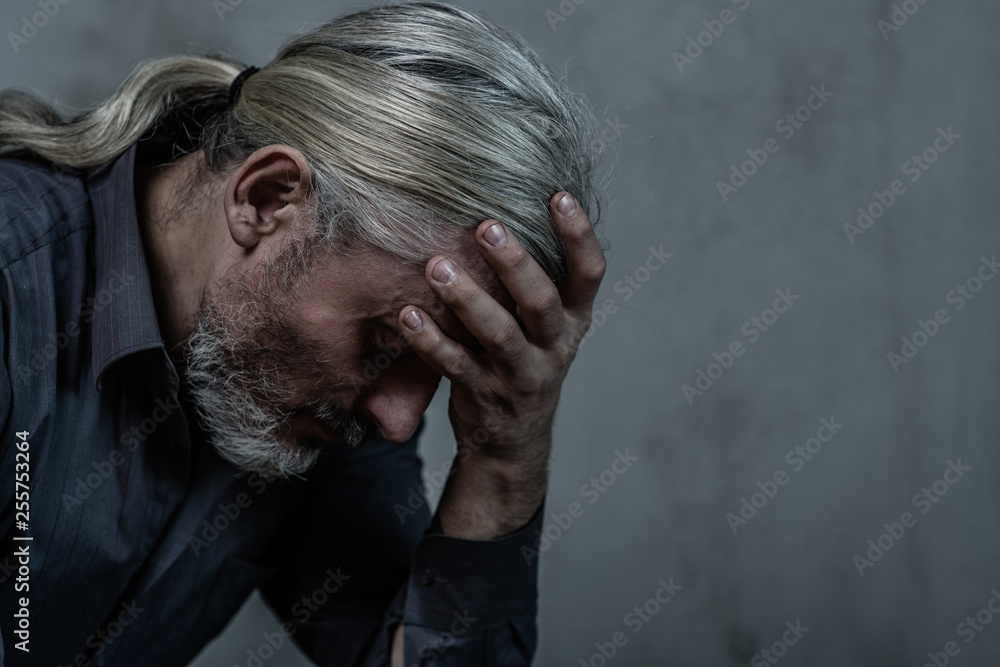 Sad man on dark background. Empty space for text Sad man on dark background. Empty space for text