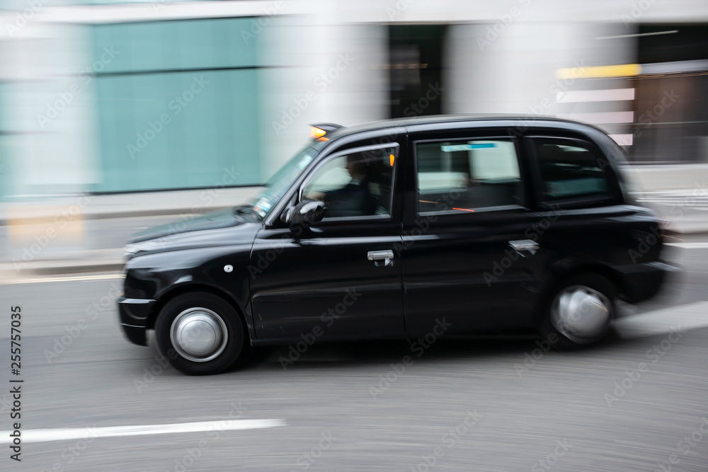 Black cab taxi  in motion on the street in Central London