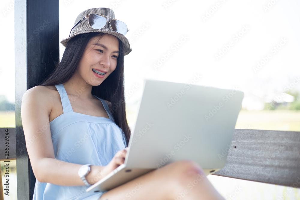 Beautiful young woman using laptop