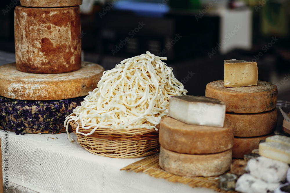 Cheese set on stand at street food festival in city. Different types of cheese, brie, blue,gorgonzola,goat, parmezan on wooden table.Street food festival Cheese set on stand at street food festival in city. Different types of cheese, brie, blue,gorgonzola,goat, parmezan on wooden table.Street food festival