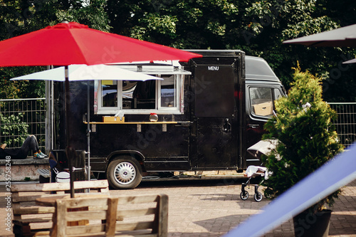 Wallpaper Mural Food van truck. Stylish black mobile food truck with burgers and asian food at street food festival. Summer eating market in the city. Space for text, menu Torontodigital.ca