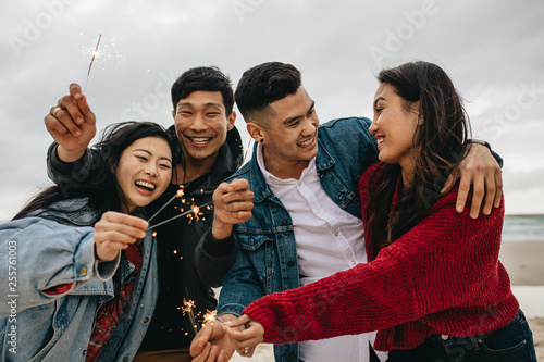 Group of asian friends celebrating new year's day ay beach photo