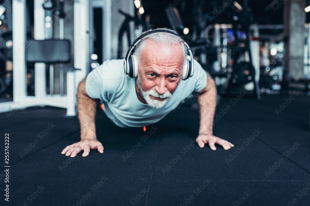 Fototapeta premium Senior man exercising at gym.