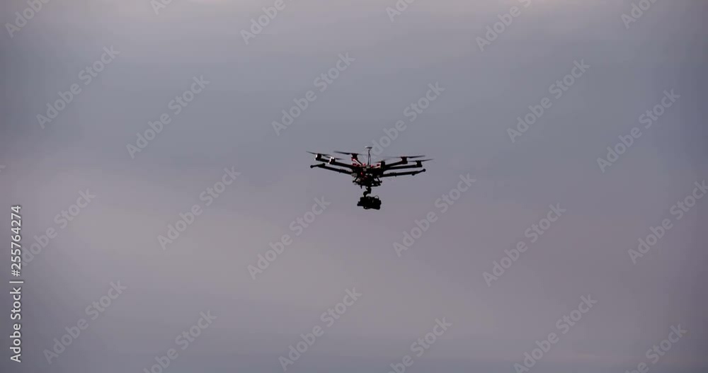 Drone Flying in the Sunset. Shooting copter flies over the rocky terrain at sunset Drone Flying in the Sunset. Shooting copter flies over the rocky terrain at sunset