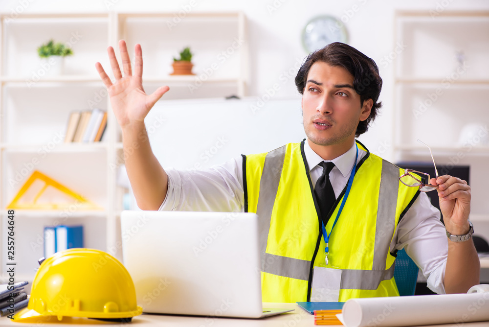 Male construction engineer working in the office Male construction engineer working in the office