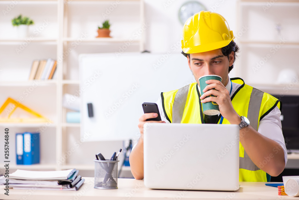 Male construction engineer working in the office Male construction engineer working in the office