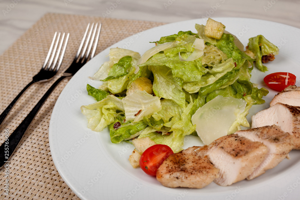 Stewed chicken fillet with tomato and cabbage salad. Stewed chicken fillet with tomato and cabbage salad.