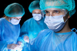 Group of surgeons in masks performing operation. Medicine, surgery and emergency help concepts