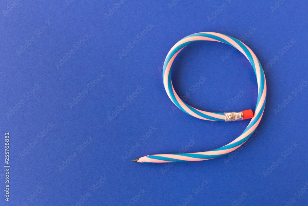 Flexible pencil . Isolated on blue background. Bending pencil. Flexible pencil . Isolated on blue background. Bending pencil.