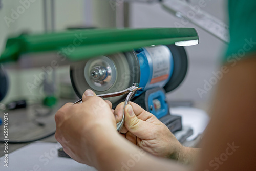 master man sharpens the machine scissors so they were sharp