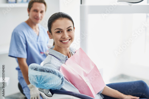 Beautiful young lady posing at modern dental office