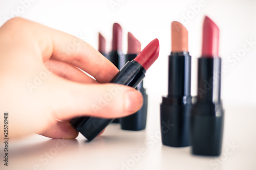 Taking a lipstick  Female hand is taking an elegant  red lipstick