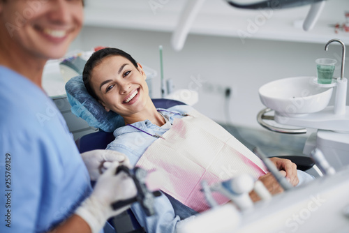 Beautiful young woman waiting for dental treatment at modern clinic