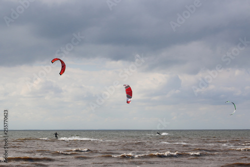 kitesurfers ridinh on the sea
