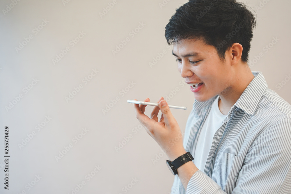 close up young asian man holding smartphone and talking by use voice control function for call with others, lifestyle technology concept close up young asian man holding smartphone and talking by use voice control function for call with others, lifestyle technology concept